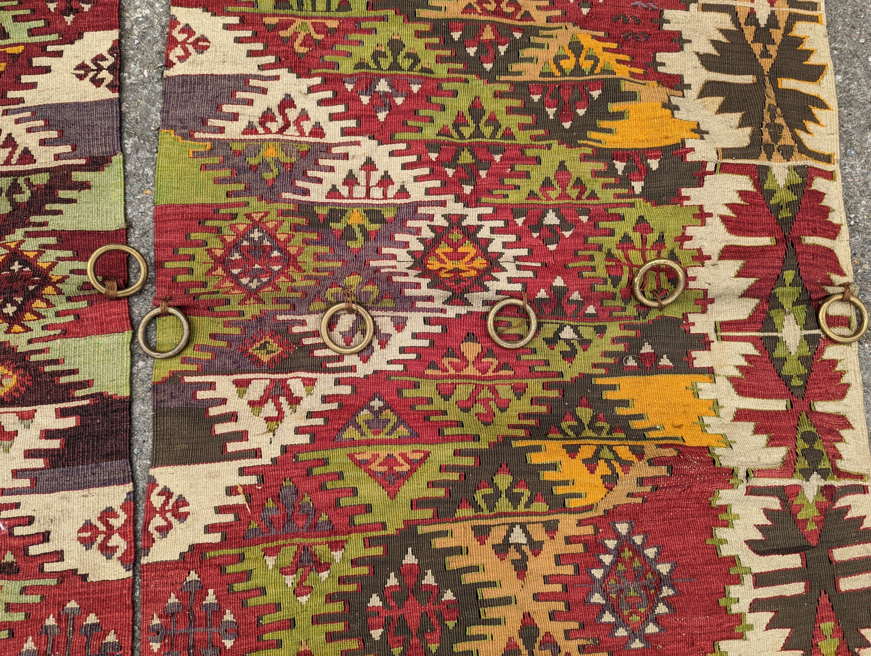 A Kelim polychrome flatweave carpet, cut centrally to create a pair of runners, each 410 x 85cm